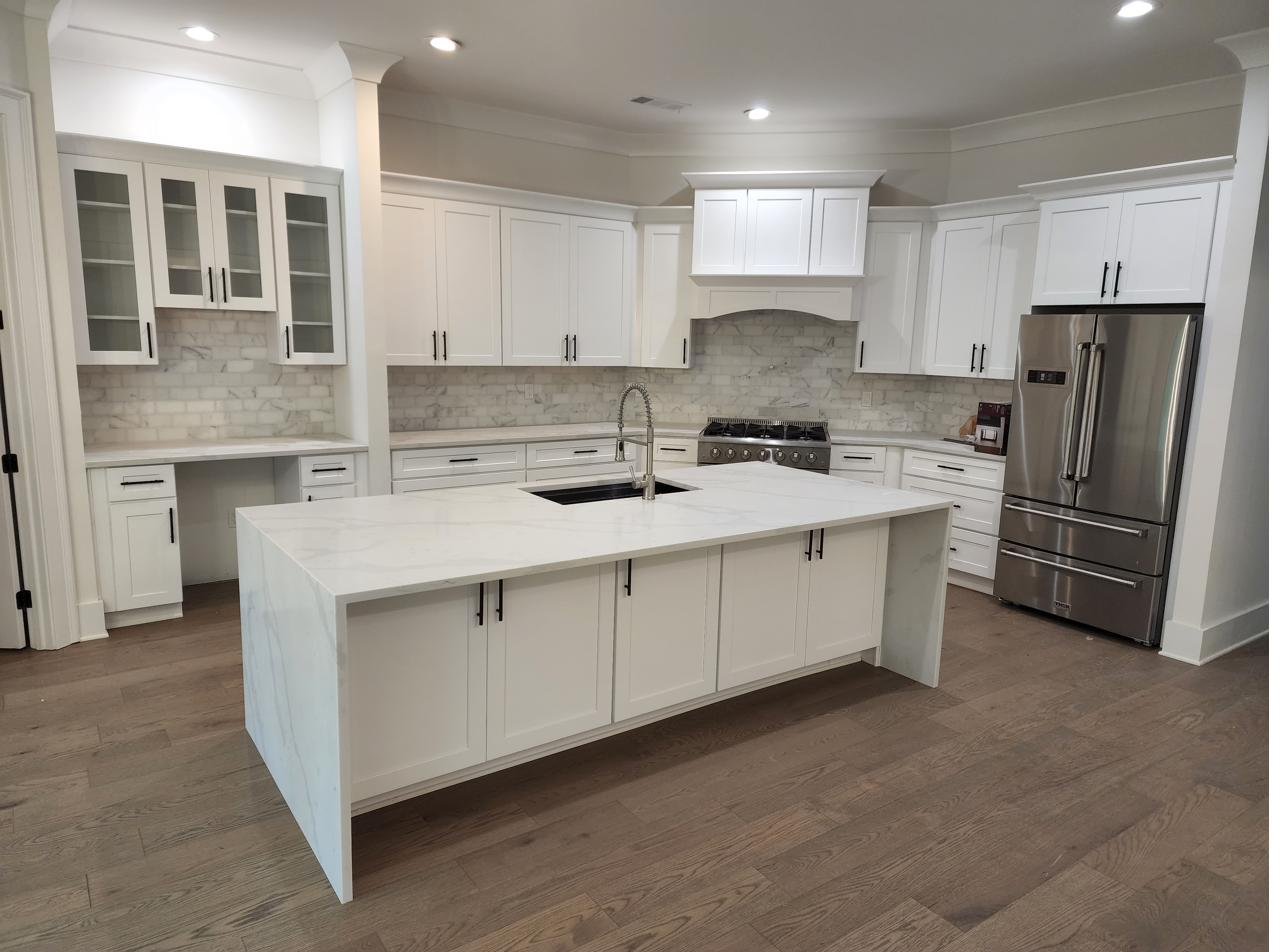 A finished kitchen with a center island and sink