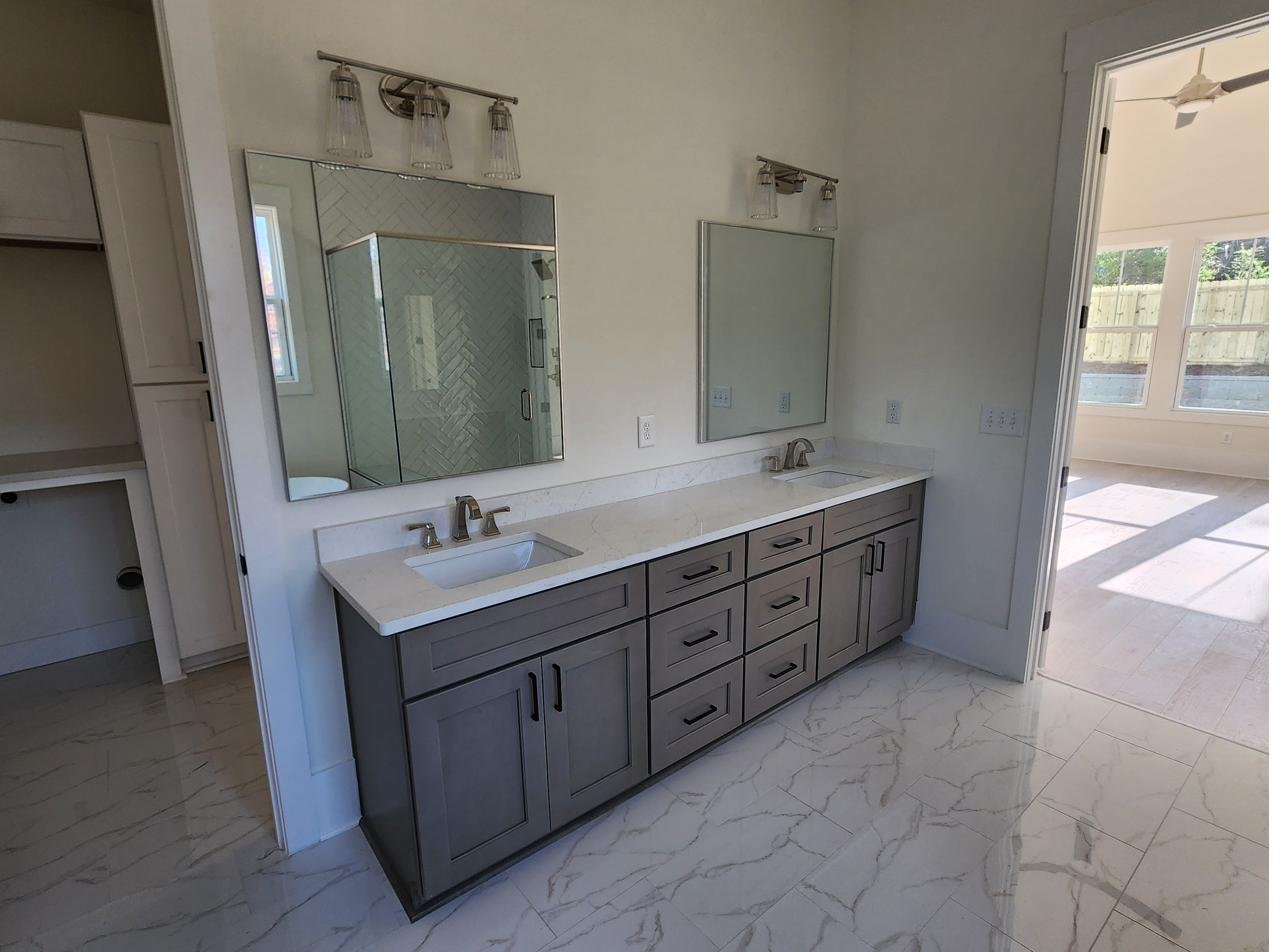 A double-sink bathroom vanity with a stone countertop