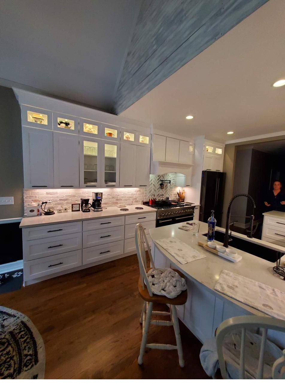A finished kitchen with a beamed ceiling and a large island