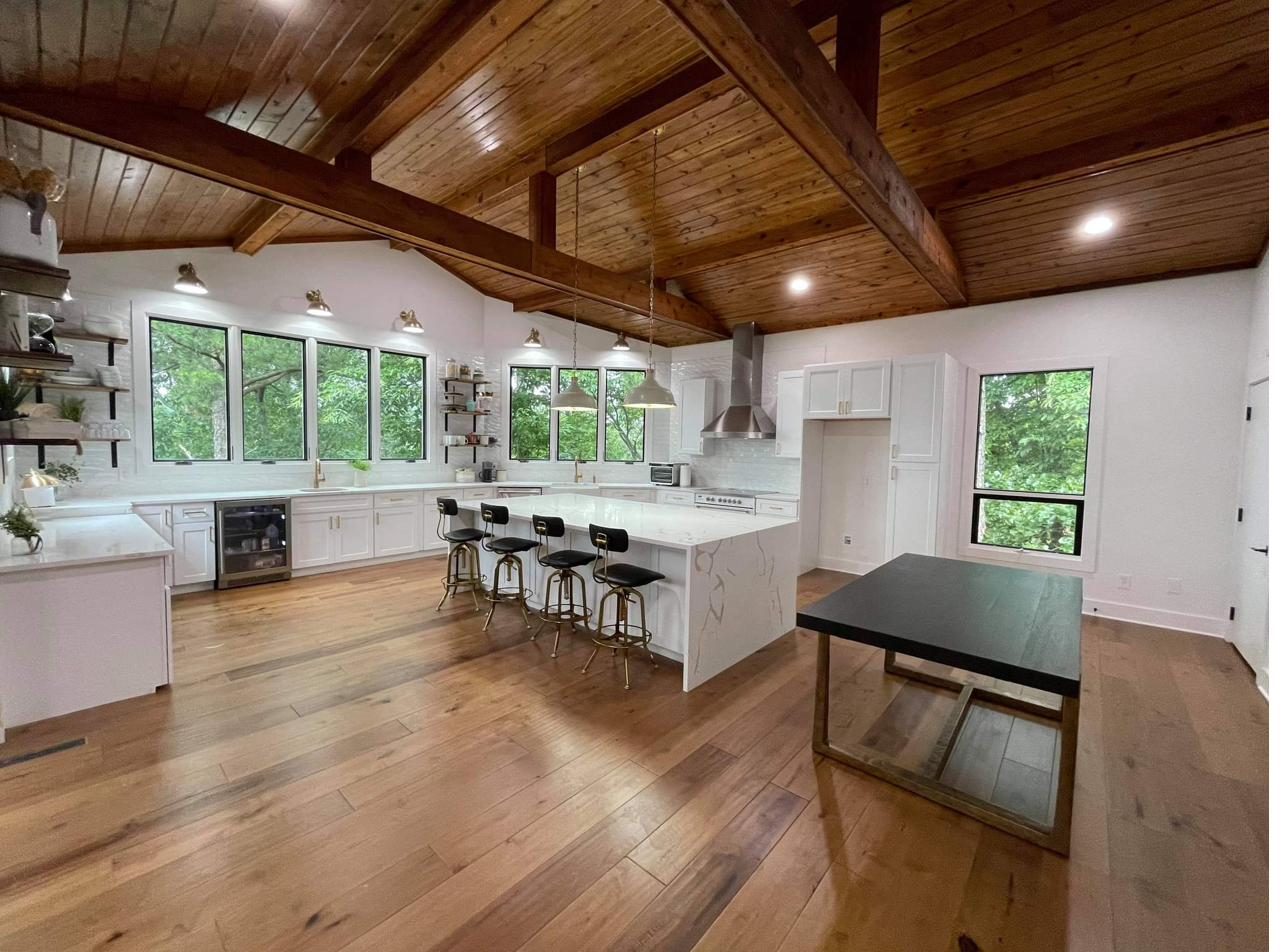A bright kitchen with a vaulted wood ceiling