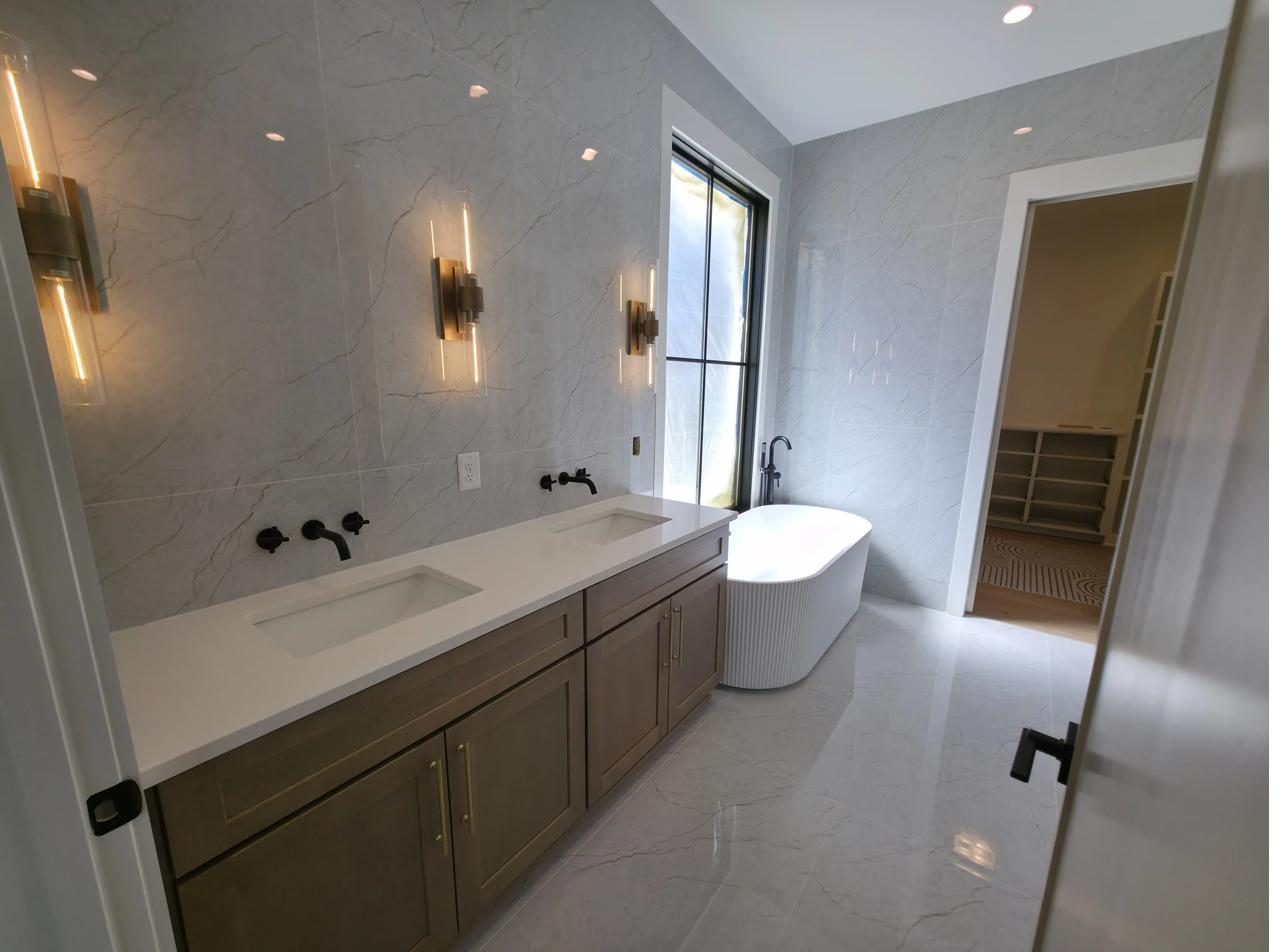 A finished bathroom remodel with a marble-tiled shower